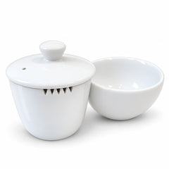 White ceramic tea set with a lidded gaiwan and a matching teacup on a clean white background.