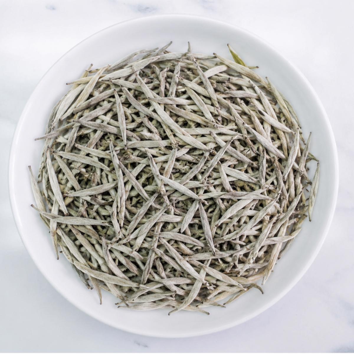 Premium Ceylon Silver Tips white tea handcrafted from unopened tea buds with pale golden infusion by Johns Ceylon Tea UK