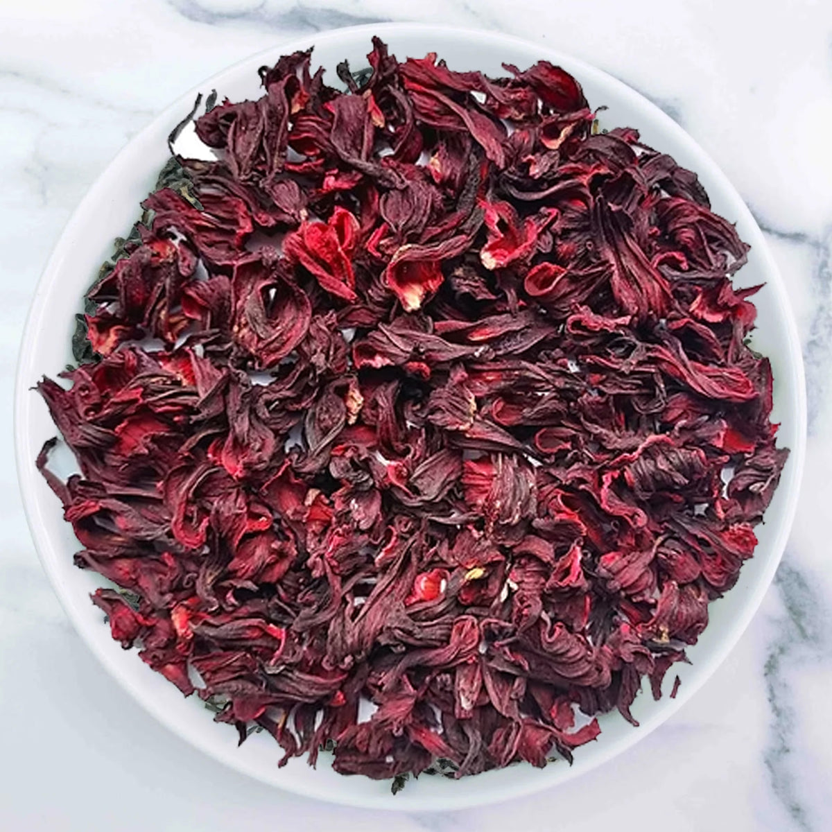 Hibiscus Tea with vibrant ruby red herbal infusion made from dried hibiscus flowers by Johns Ceylon Tea UK